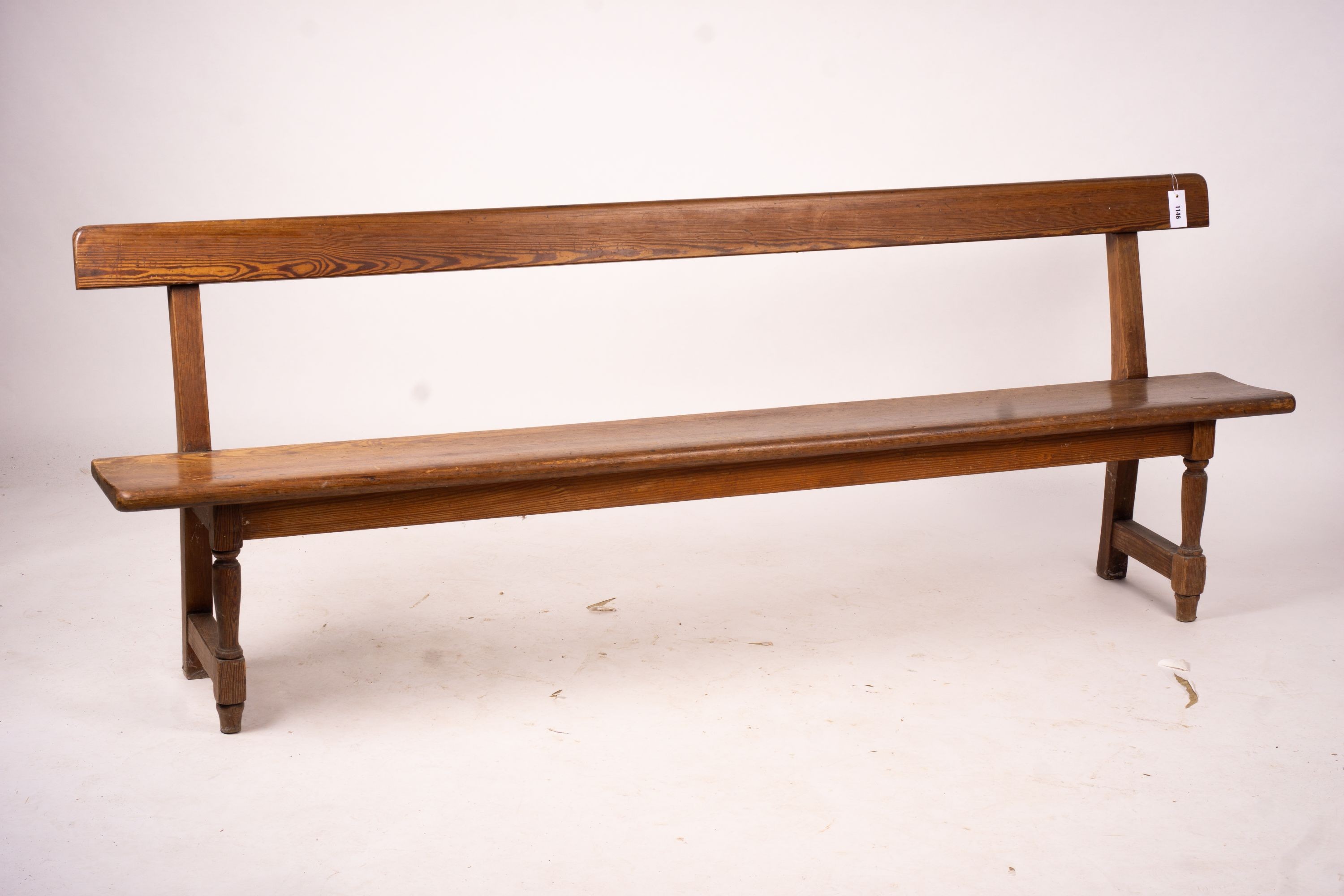 A Victorian pitch pine bench seat, W.214cm H.79cm